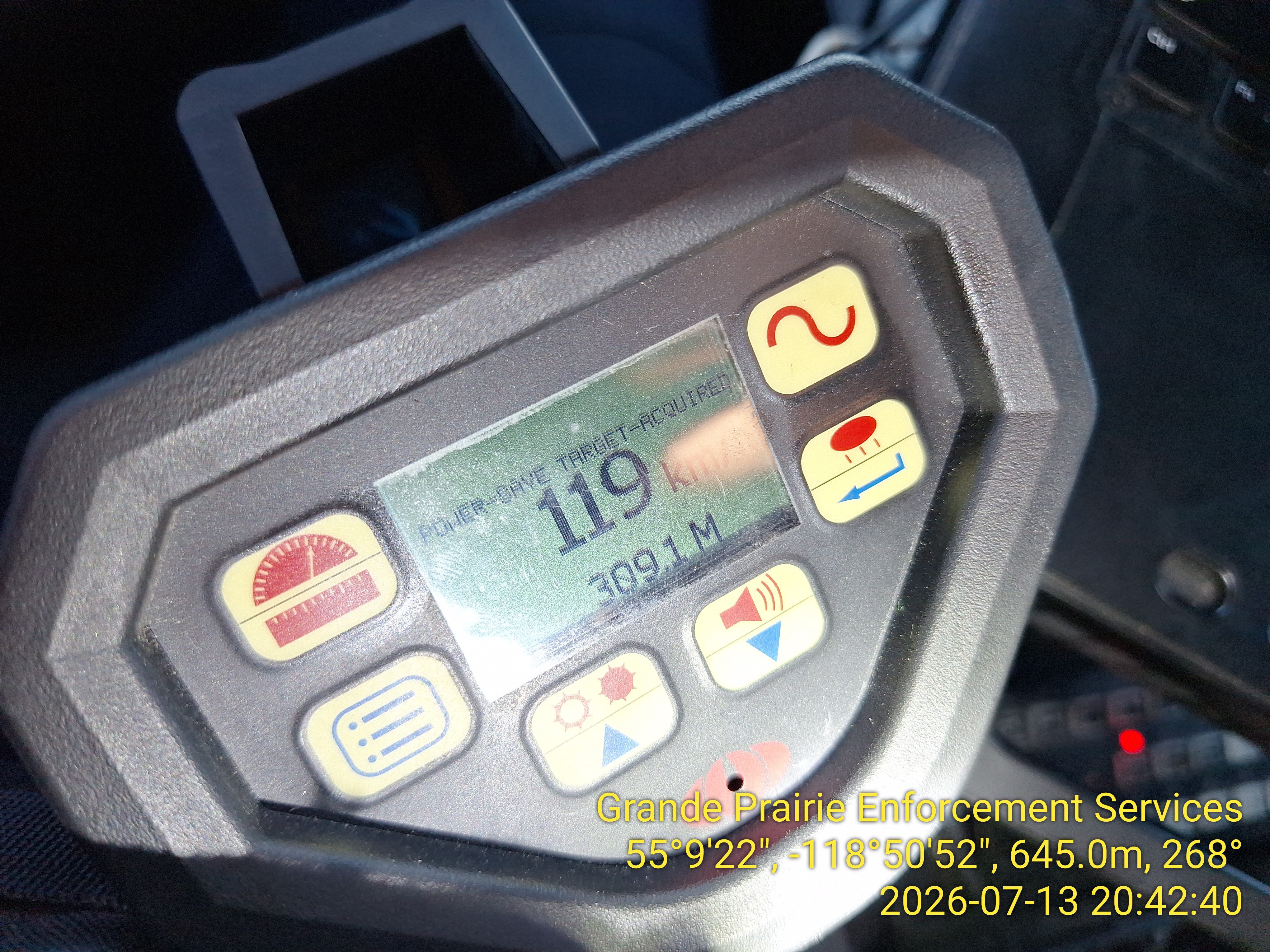 A photo radar gun showing a speed of 119 km/h