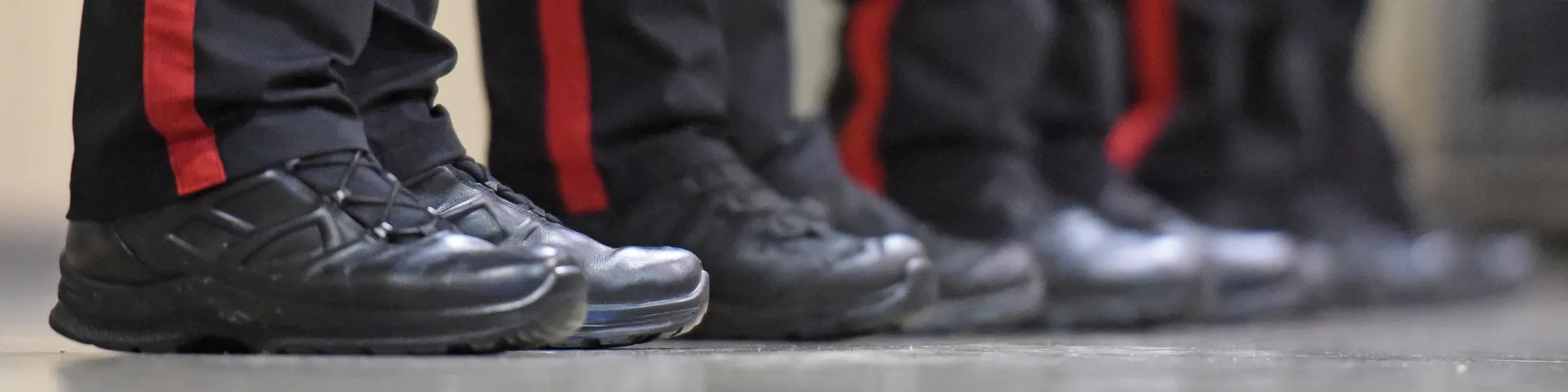 The boots of officers and red stripes on their pants