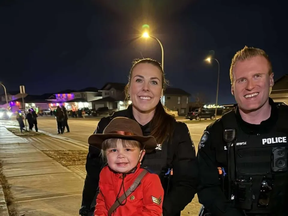 Grande Prairie Police Service members with a trick-or-treater